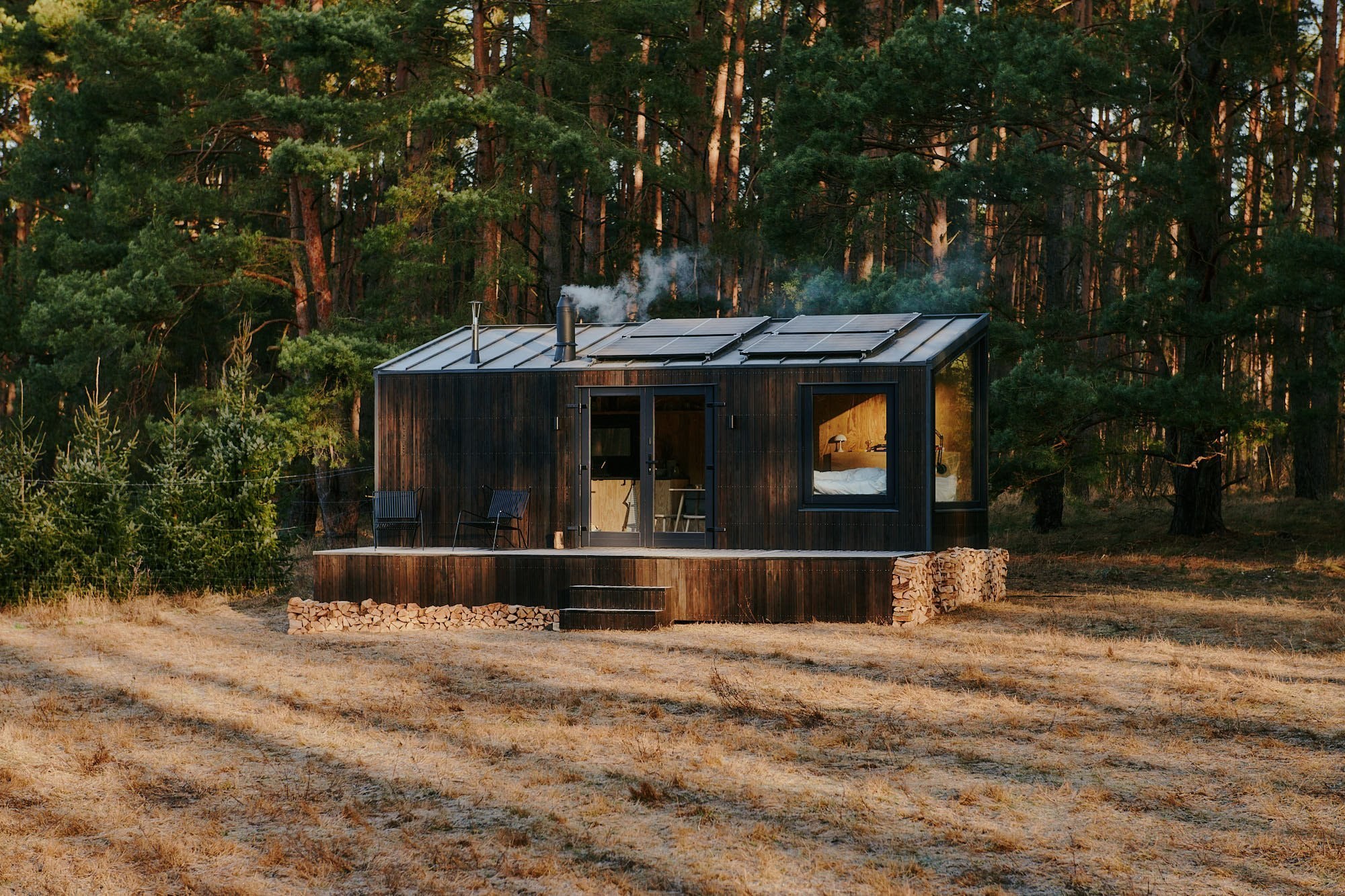 StayRaus cabin in the forest at dusk